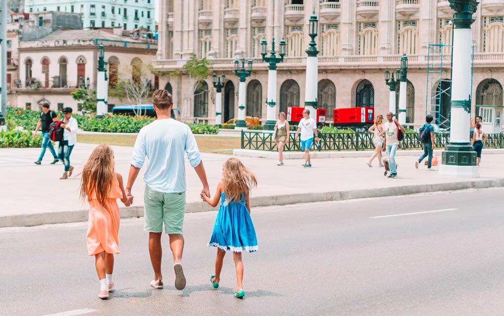 Family in old Havana lookina at popular El Capitolio